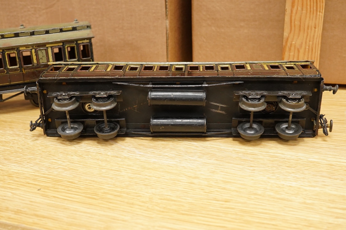 Three Carette for Bassett-Lowke 0 gauge tinplate GWR clerestory bogie coaches; two First Third Composite coaches, both 1324, and a full brake van, 1334, all in chocolate and cream livery
